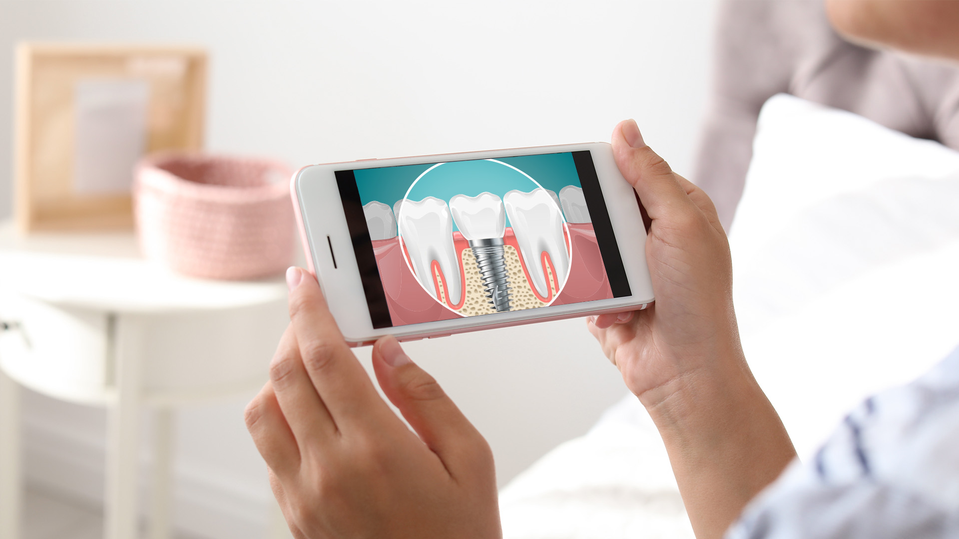 The image shows a person holding a smartphone with an app open displaying a toothbrush brushing teeth, indicating dental hygiene or oral health care.