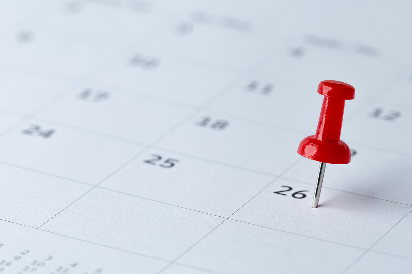 The image displays a calendar with a red thumbtack pointing at the 16th of February, indicating an appointment or event scheduled for that day.