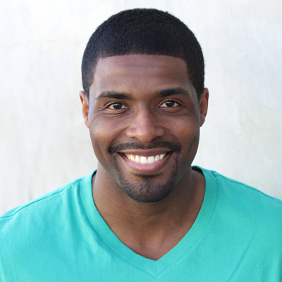 An elderly couple sharing a joyful moment together while posing for a photograph.
