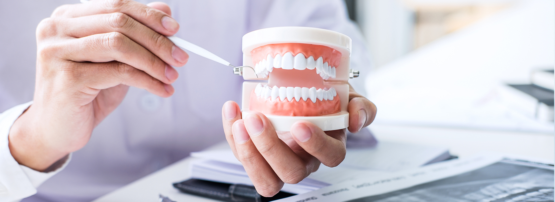 The image depicts a person holding a toothbrush with toothpaste, possibly suggesting dental hygiene or a dental care product.